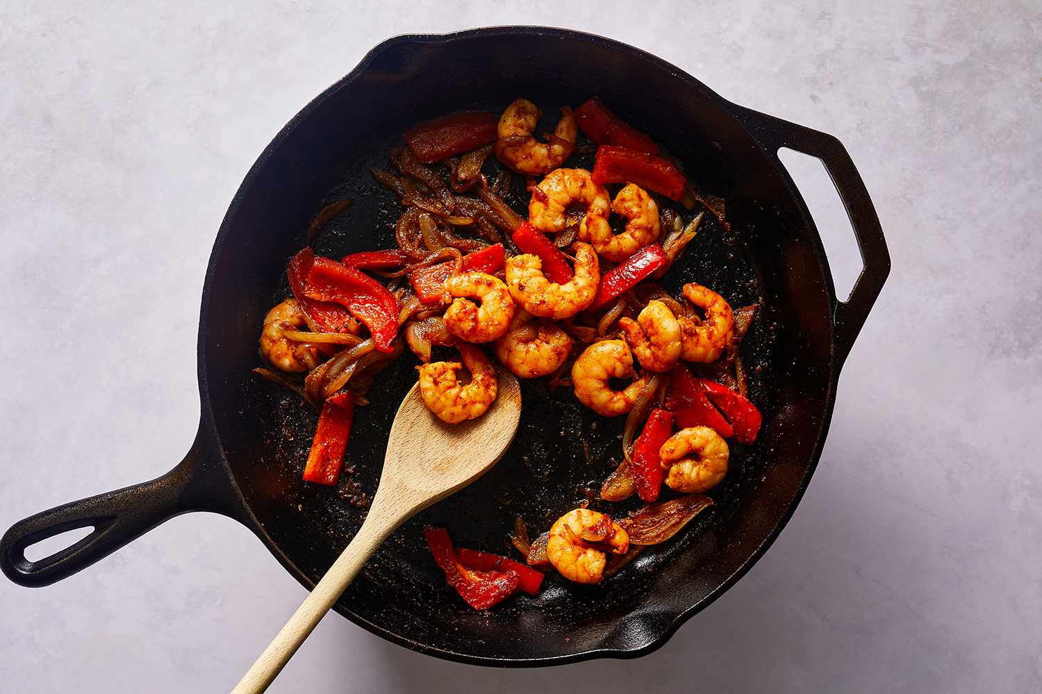 Onions, peppers and shrimp in a skillet 