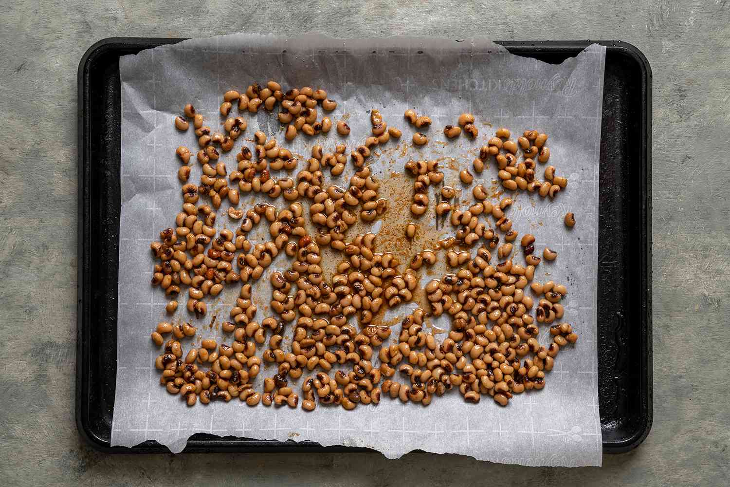 Black eyed peas on a parchment paper lined baking sheet 
