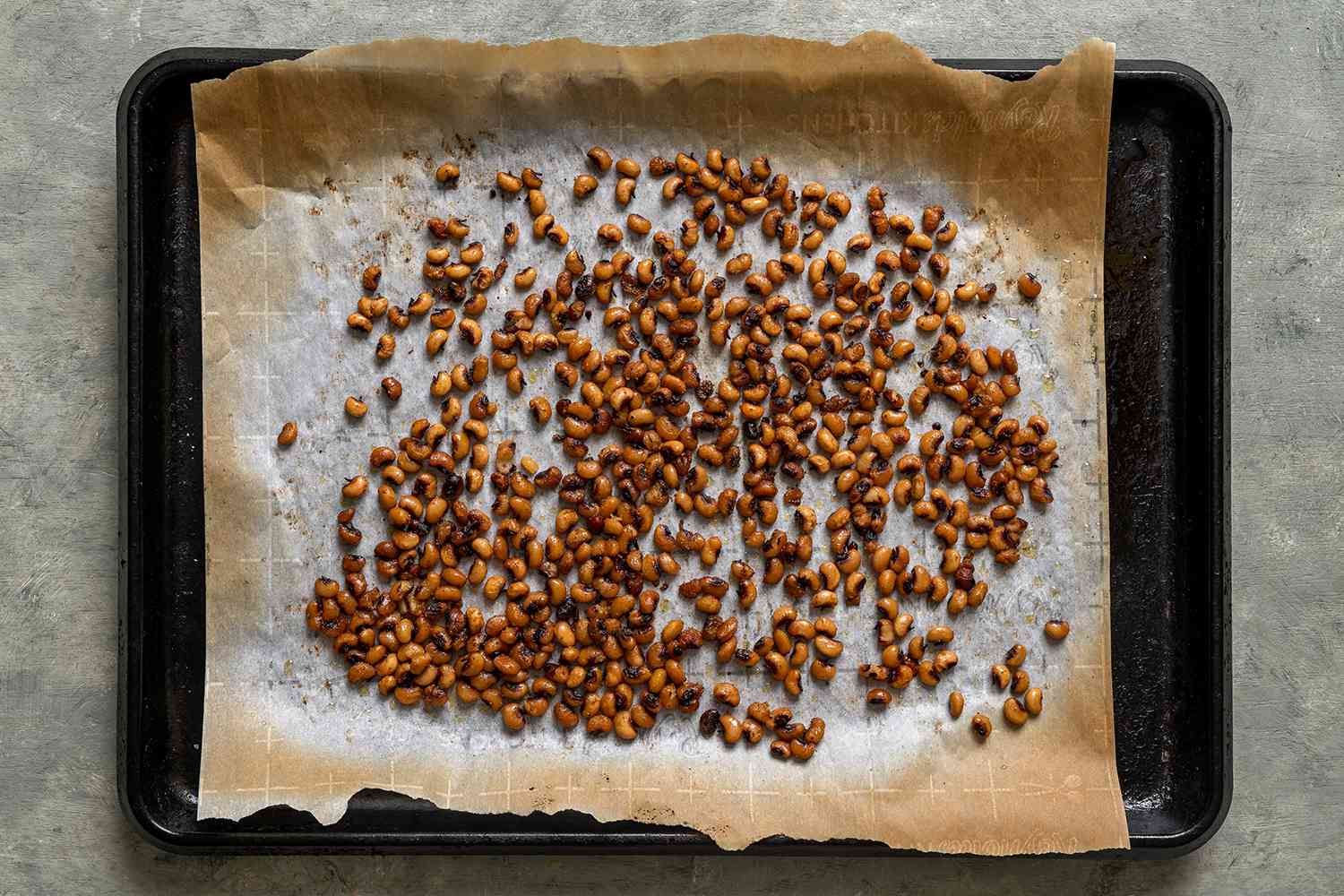 Baked black eye peas on a parchment paper lined baking sheet 