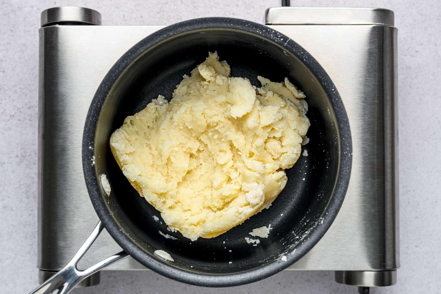 A pot with thick, lumpy dough