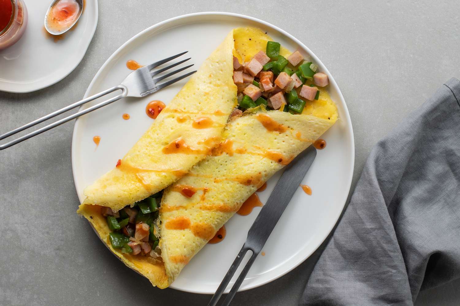 Denver omelet fillet with diced ham and green bell pepper on a plate
