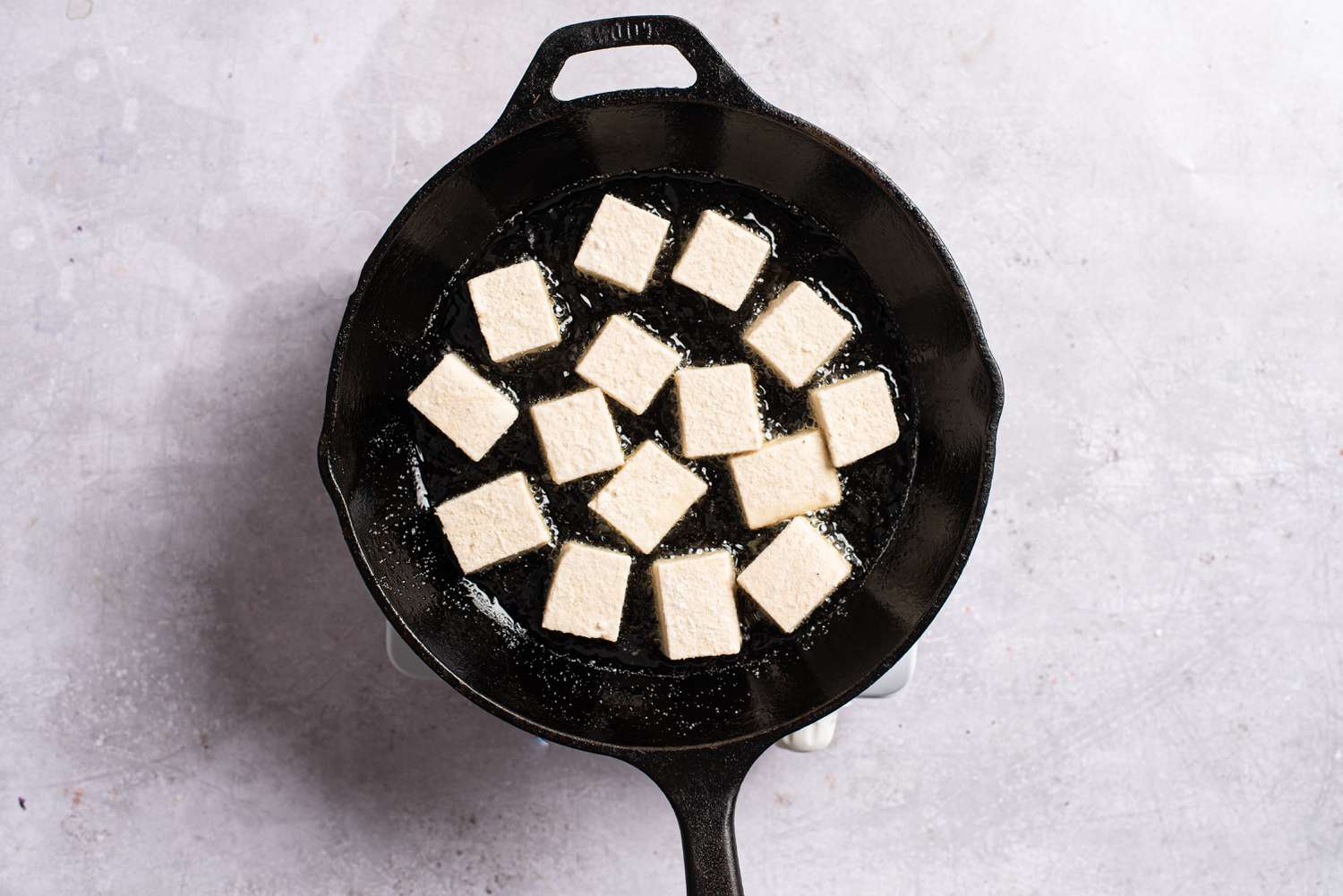 Tofu frying in a pan