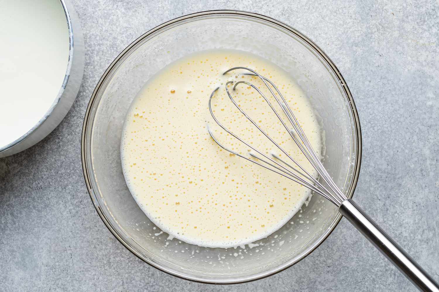 Adding warm milk mixture to the egg mixture