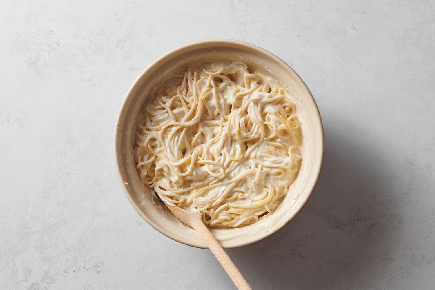A bowl of spaghetti tossed in ricotta, cream cheese, eggs, and black pepper