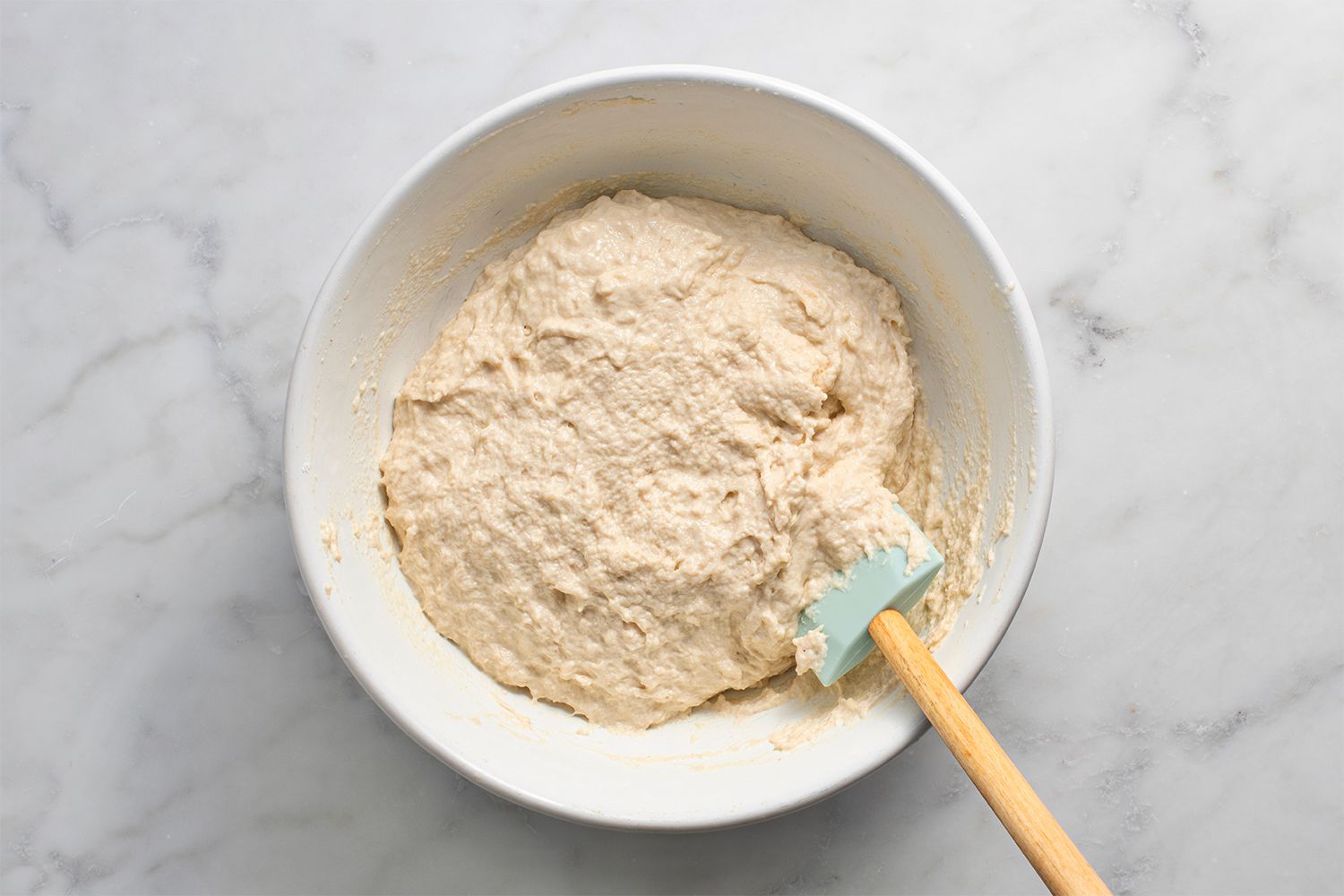Dough in a bowl with a spatula 