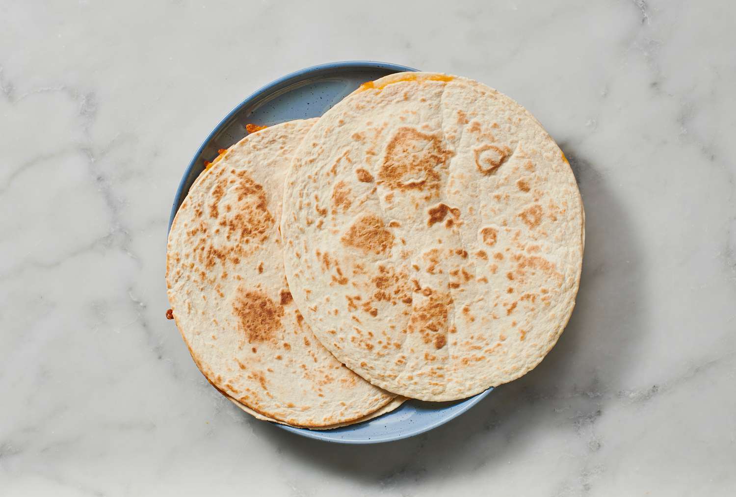 A plate with two cheese quesadillas