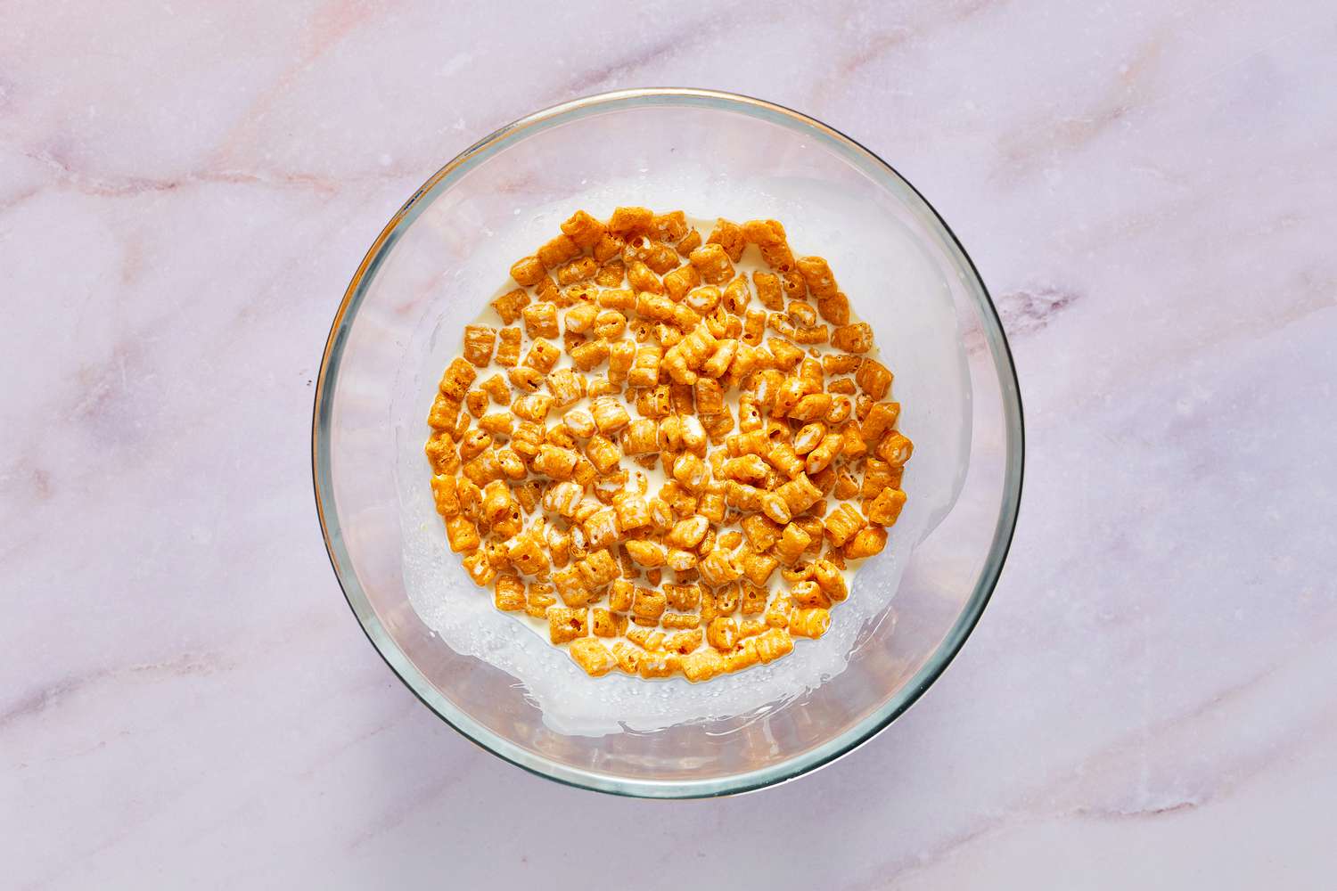 A bowl of Cap'n Crunch cereal soaking in heavy cream