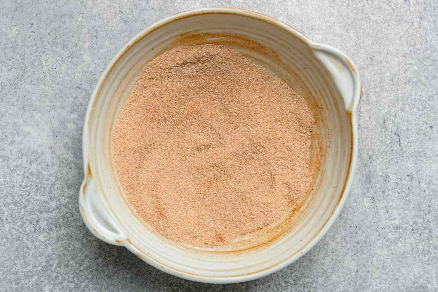 A bowl of cinnamon and sugar