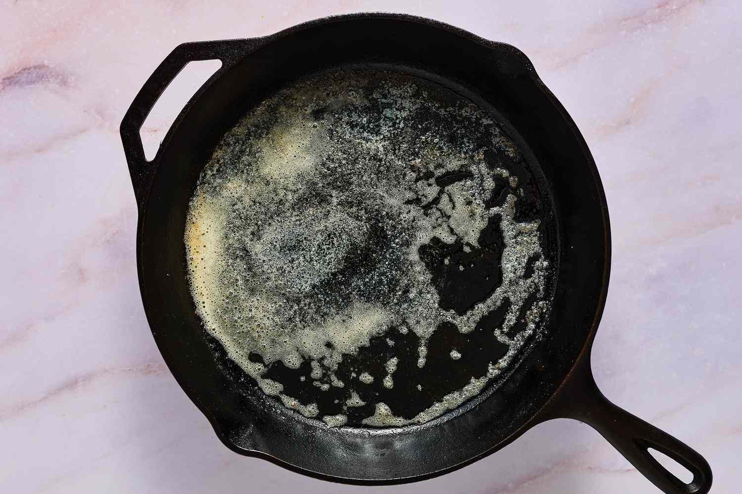 A large skillet coated with bubbling butter