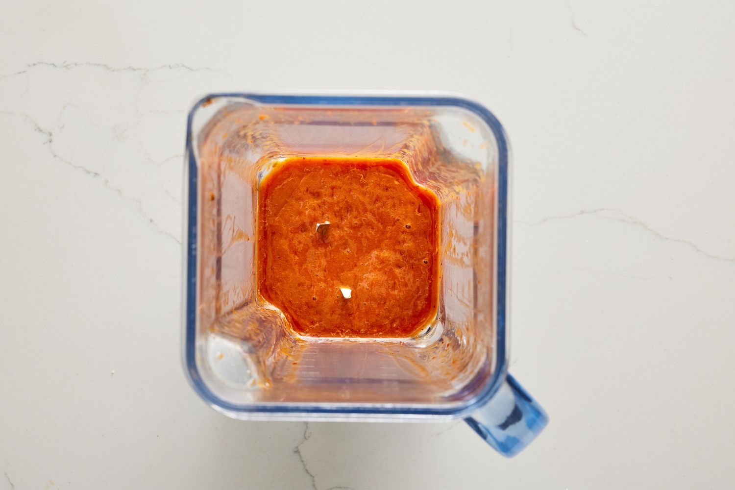 A blender with a smooth honey-chili sauce