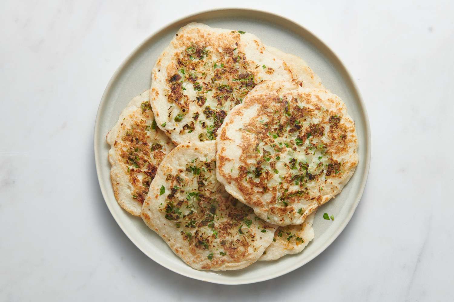 A platter of cooked uttapam